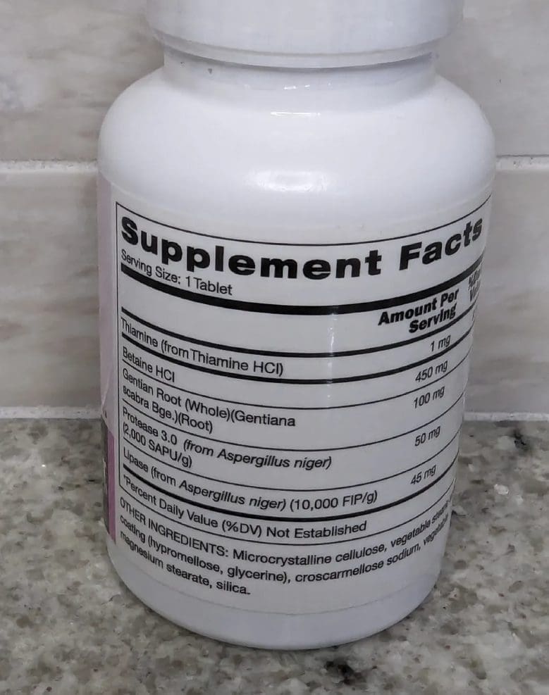 A bottle of supplement facts on the counter.
