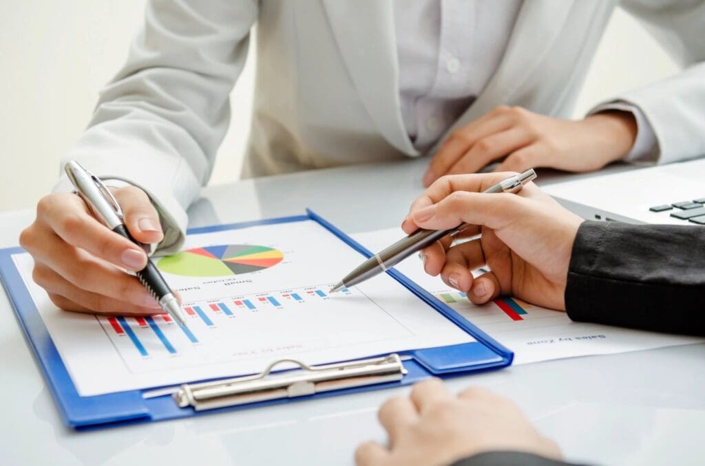 Business people reviewing sales charts.
